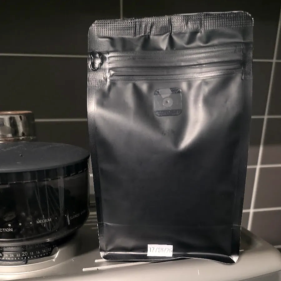 A FARCOFF bag with a roasted-on date stamp on the pouch.